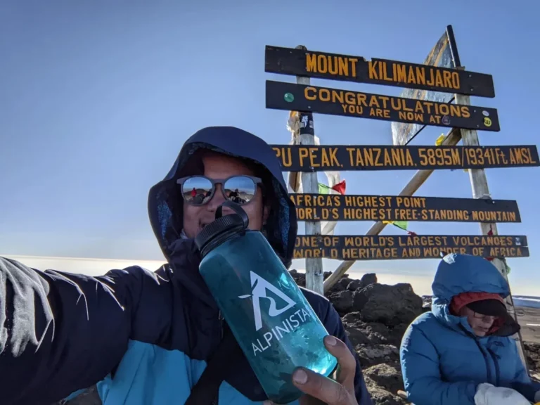 Hikers reaching Uhuru Peak during Kilimanjaro group climbs